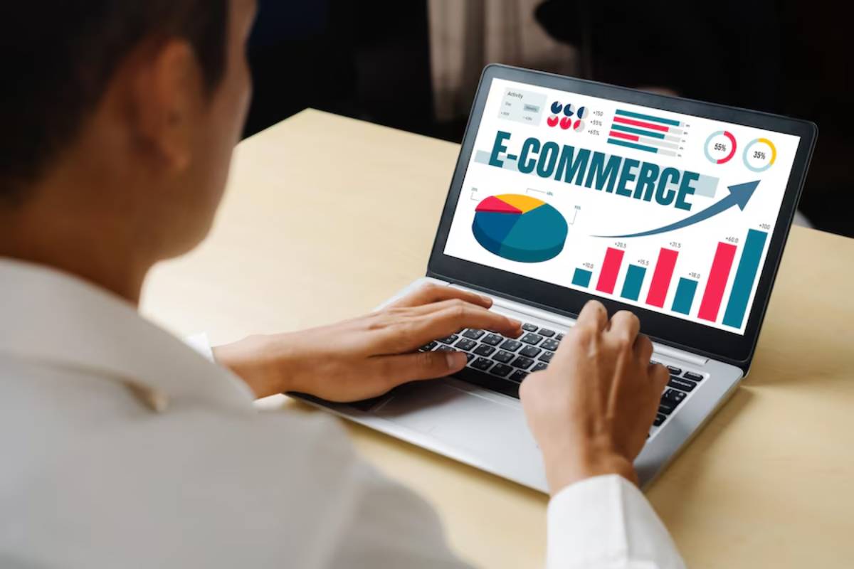 Person analyzing e-commerce statistics on a laptop, displaying colorful charts and graphs.