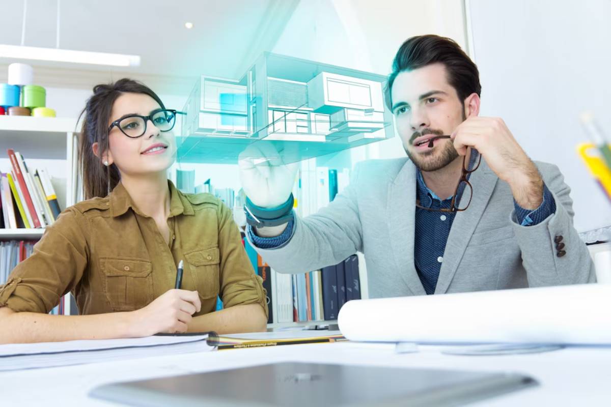 Two architects examining a holographic model of a building in a bright office.