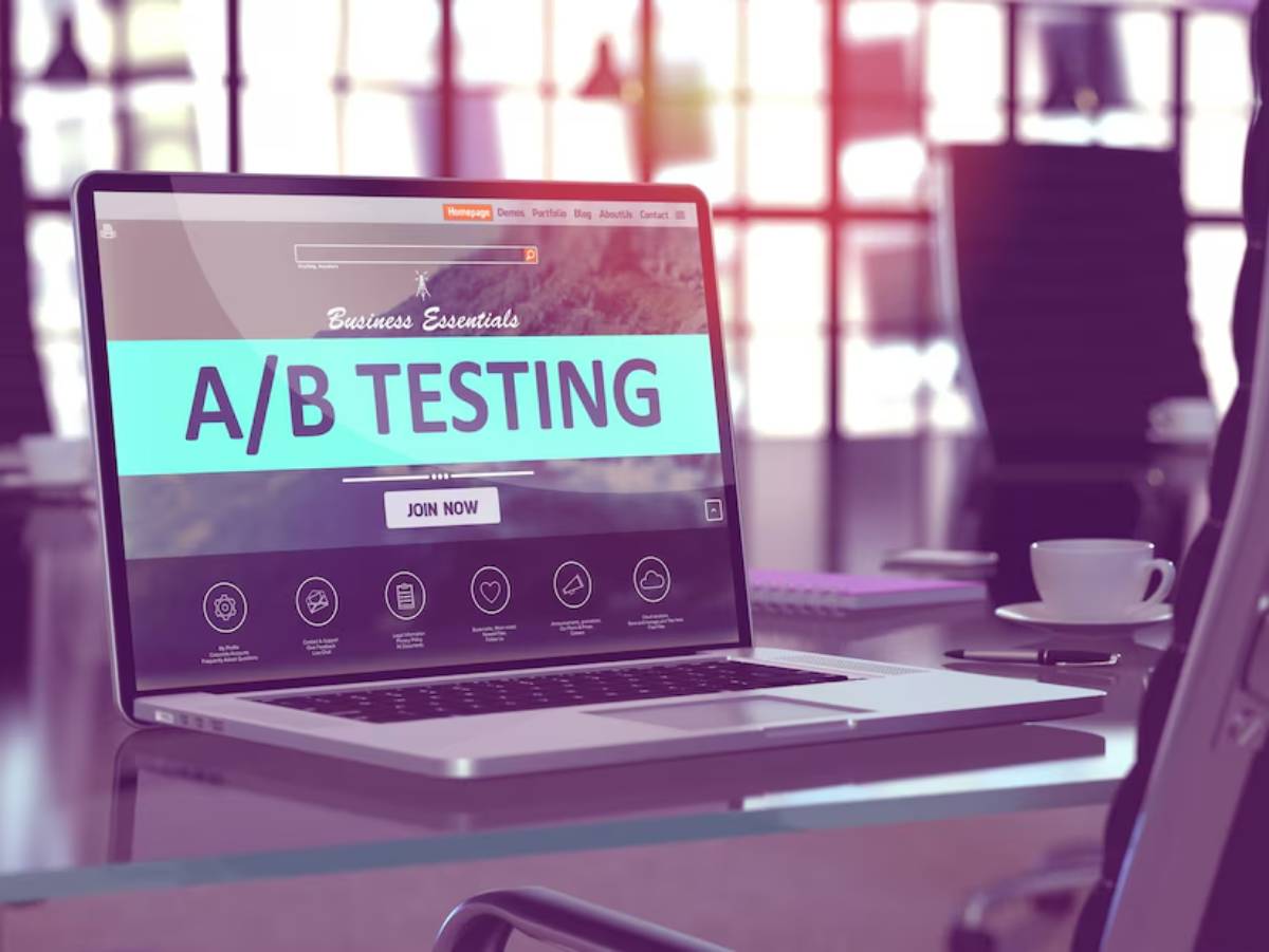 Laptop on a desk displaying a web page about A/B testing in a sunny office environment.