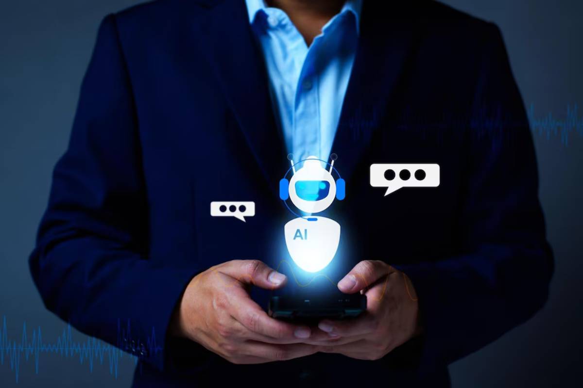 Businessman holding a smartphone displaying an AI robot with chat bubbles, illustrating digital communication technology.