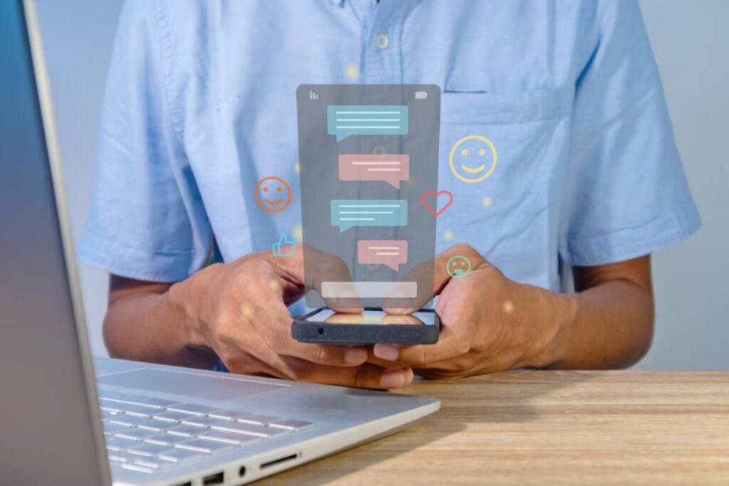 Person holding smartphone using an augmented reality interface displaying chat bubbles and social media reactions.